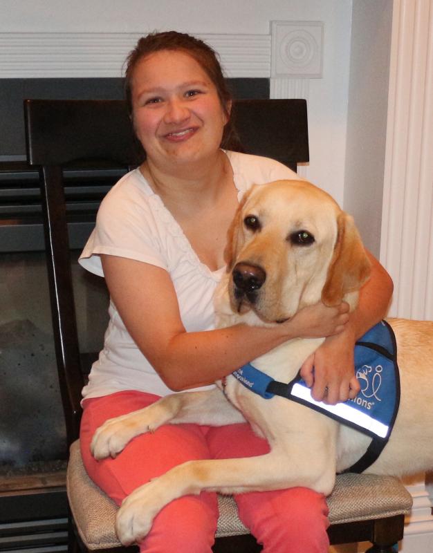 Jazmin Tinsley snuggles with her Canine Companion Bonus in their Rehoboth home. ELLEN DRISCOLL PHOTO